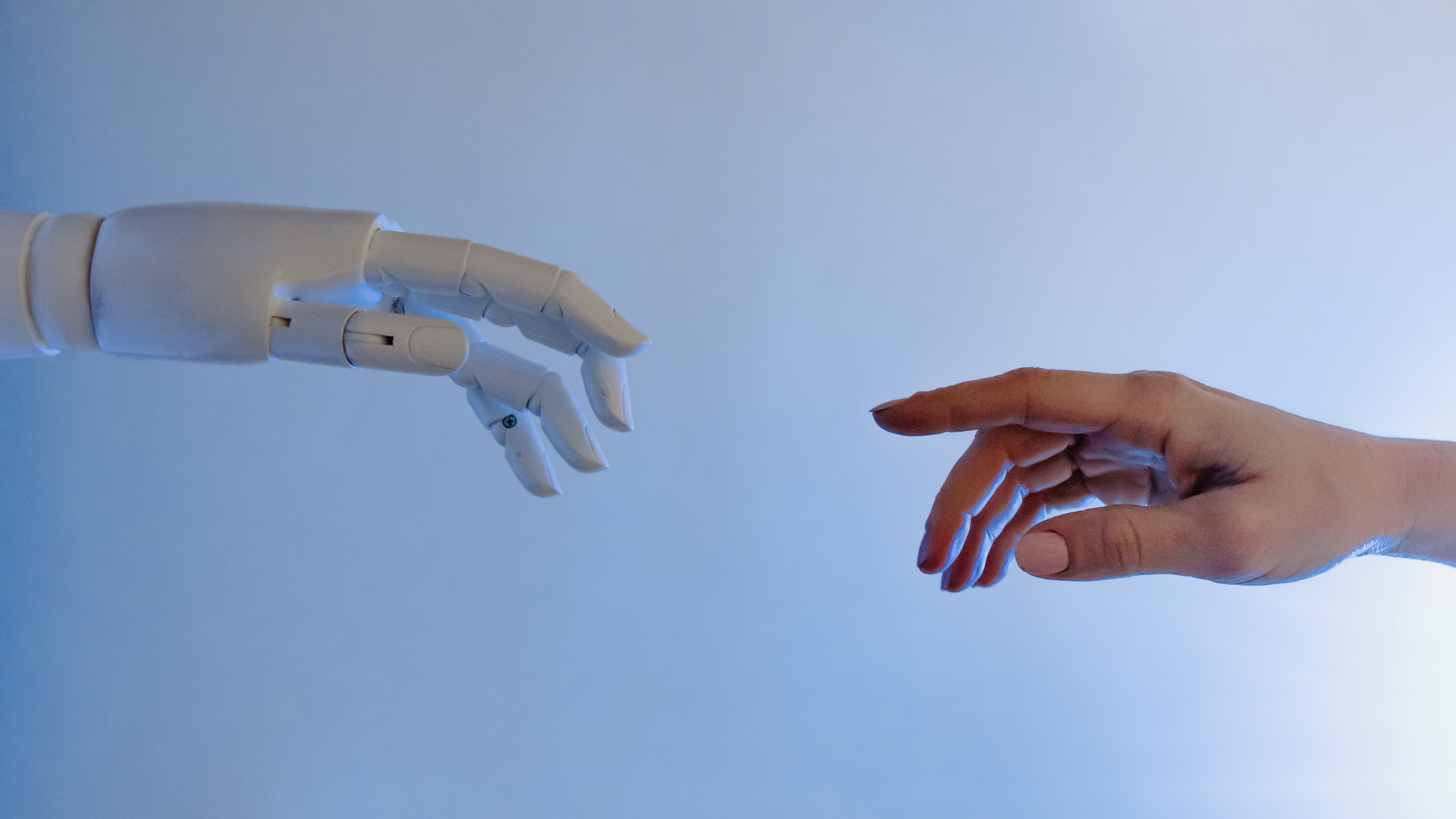 robot hand reaching to a human hand